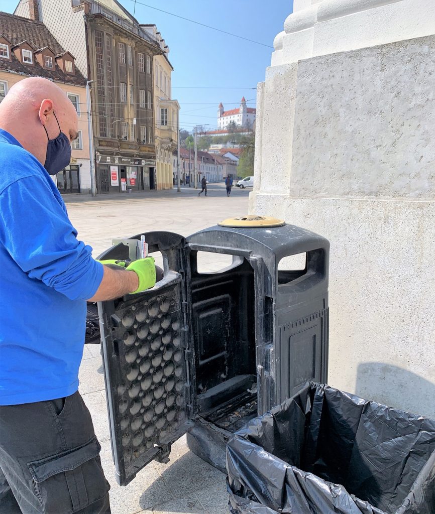 A technician installing smart sensor into the street bin in Bratislava.