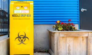 Yellow bin box for used sharps and needles.