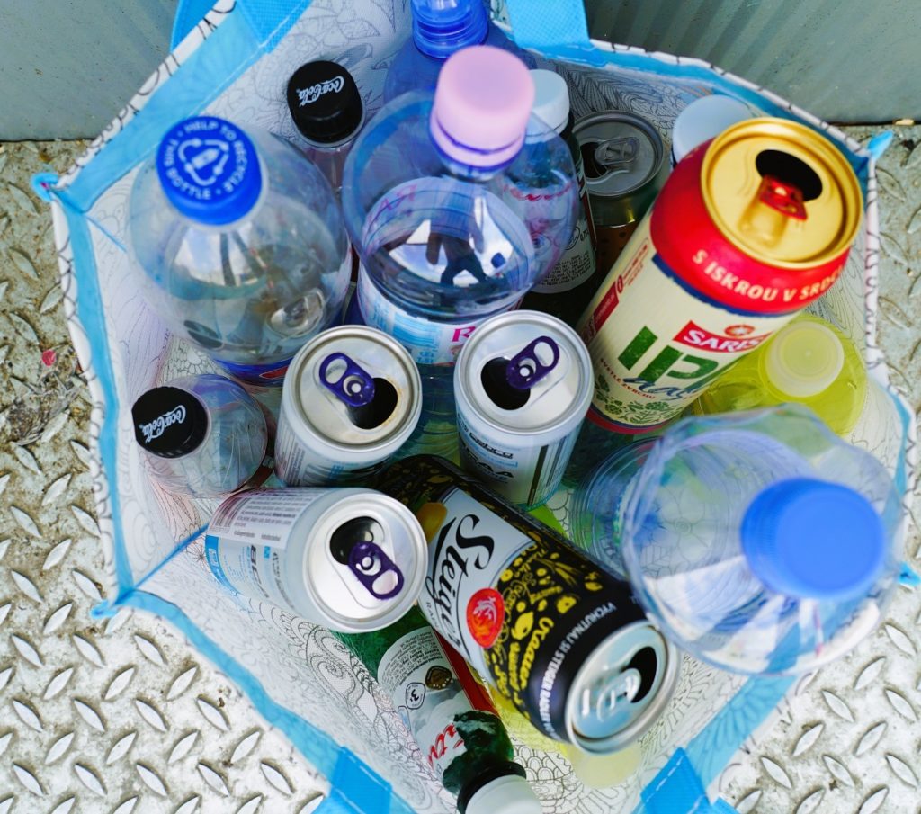 Different plastic bottles and cans in a bag. 