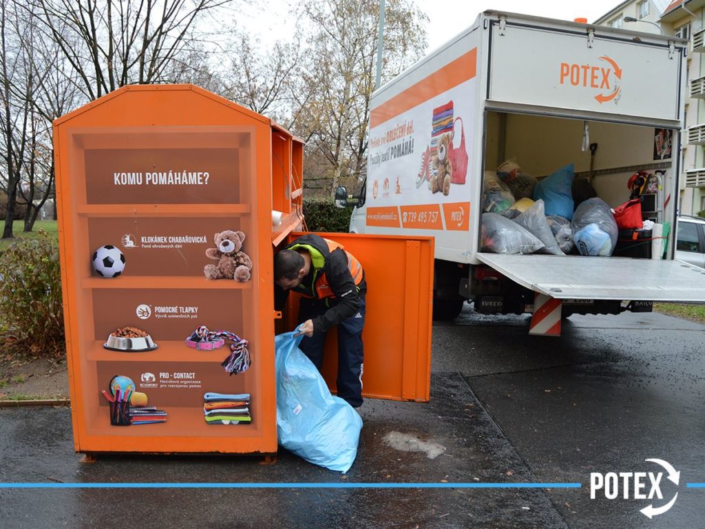 A Potex employee empties a container full of bags of old clothes.