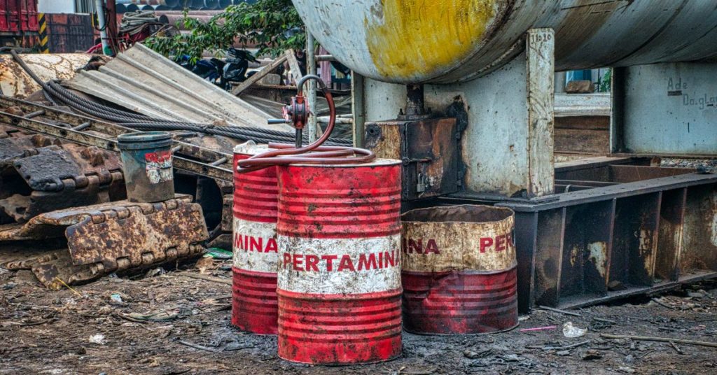 Pertamina drums of hazardous waste at junkyard.