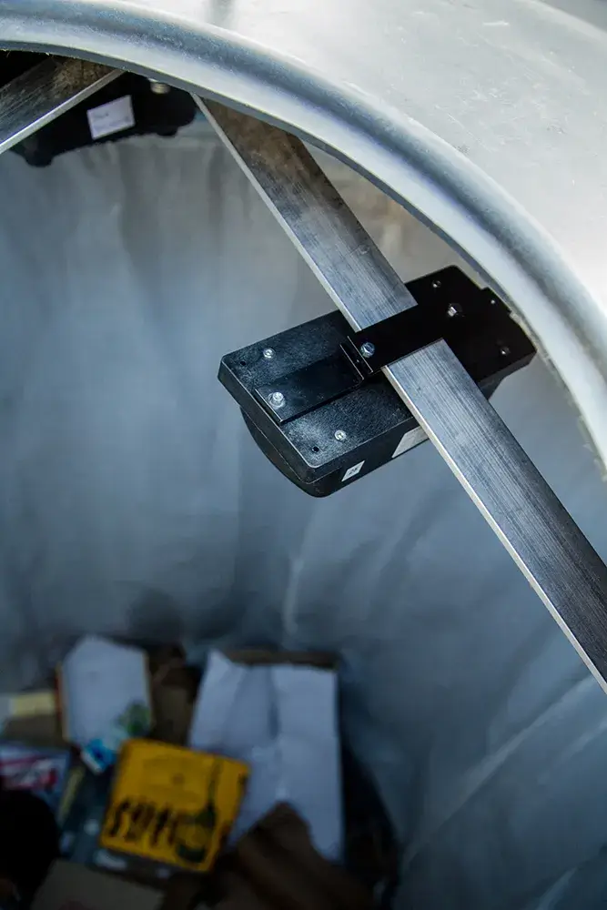 The smart sensor inside of semi-underground bin monitoring fill-level of the bin. 
