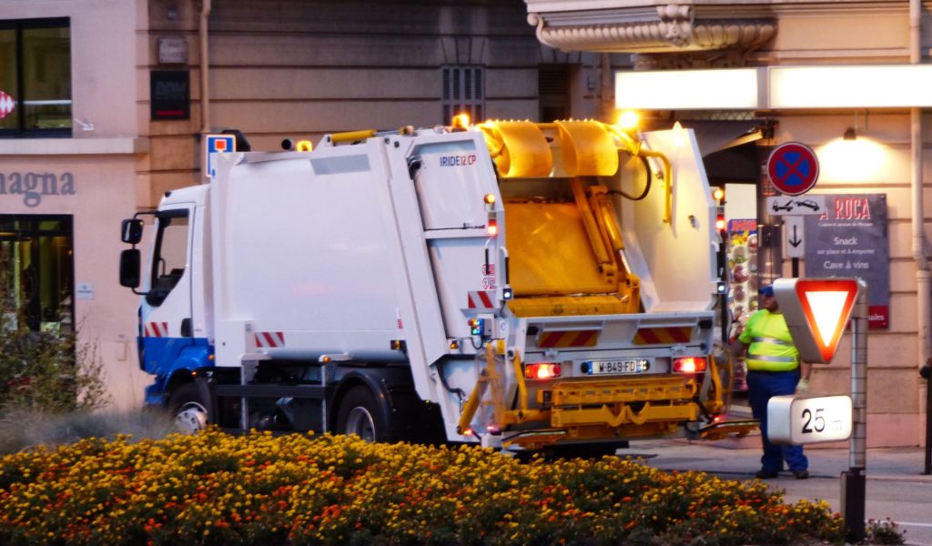 Garbage truck collecting waste in the city.