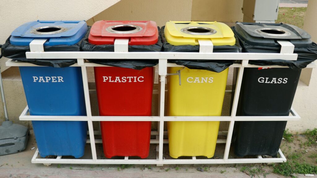 Different types of bins for paper, plastic, general waste and glass.