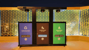 A waste sorting station with three bins that have indicators showing "FULL".