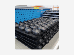 A stack of black sensor housings arranged neatly on a shelf.