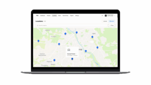 A laptop shows a take-back system dashboard, mapping collection locations for efficient e-waste logistics.