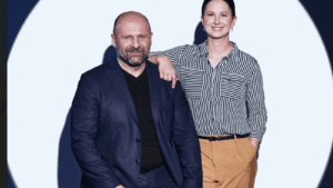 The co-founders of Sensoneo pose on stage after winning an award, the Crystal Wing.