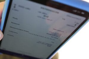 Close-up of a smartphone showing sensor settings, network info, and measurement intervals.