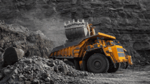 Large mining truck being loaded with rocks in an open-pit mine.