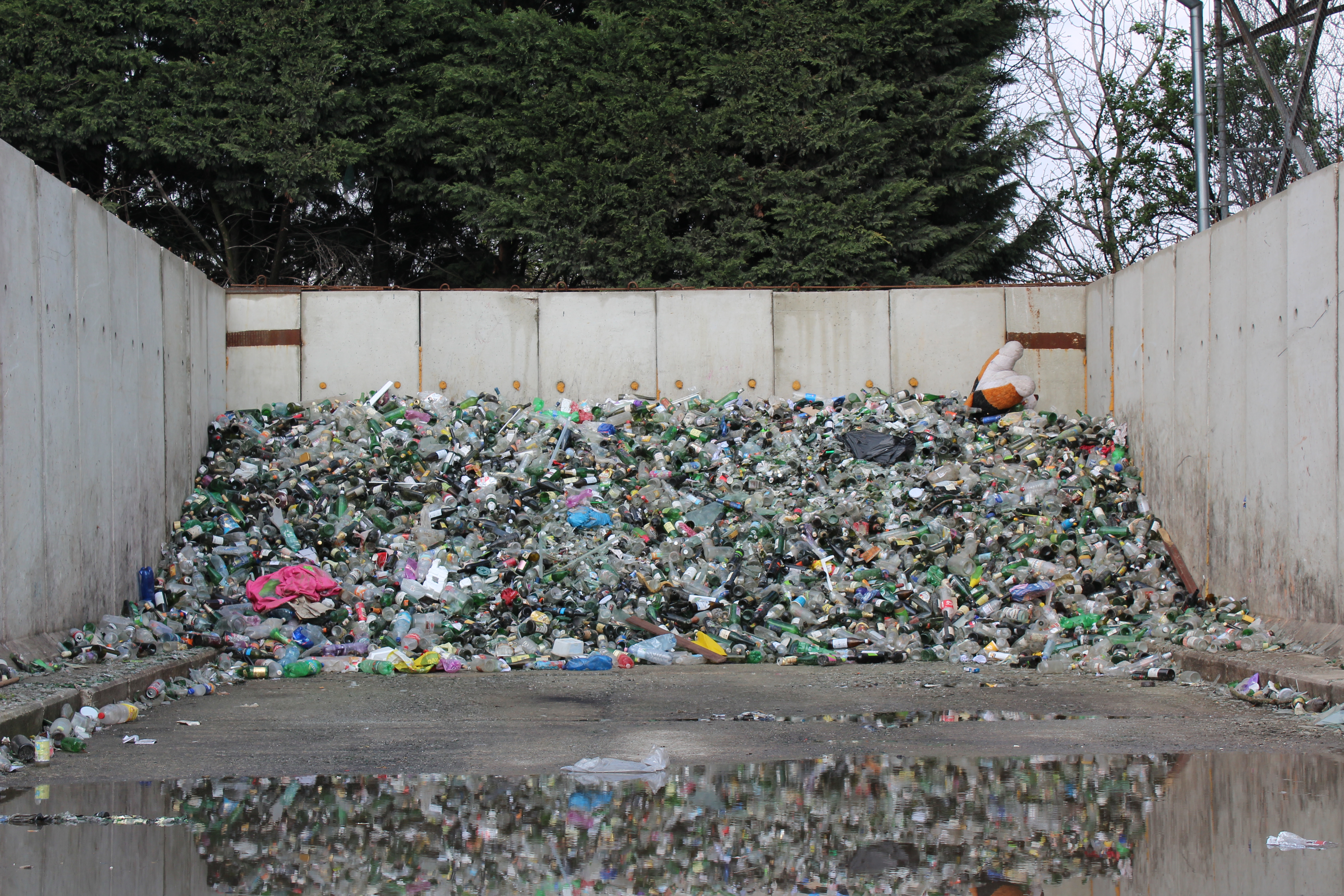 Lots of plastic bottles in a pile. 